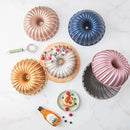 KARACA CAKE PRO Moule en fonte rose-gold KARACA CAKE PRO Dilimli Rosegold döküm kek kalıbı KARACA CAKE PRO Rosegold Gusseiserne kuchenform mit ensätzen